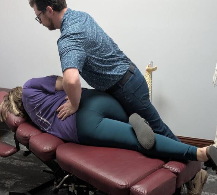 Dr. Aaron Robinson providing a chiropractic adjustment in Omaha